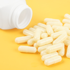 Supplement capsules spilling out of bottle image